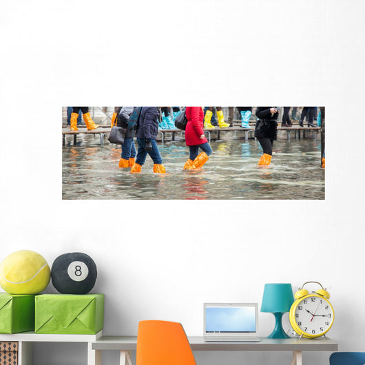 Close Up of legs with boots due to the high water in Venice. Wall Decal