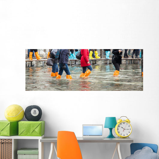 Close Up of legs with boots due to the high water in Venice. Wall Decal