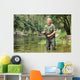 Cheerful mature fisherman fishing in a river Wall Decal