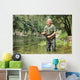 Cheerful mature fisherman fishing in a river Wall Decal