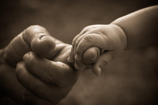 Baby hand holding mother finger with retro effect Wall Decal