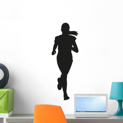 Running Young Girl Vector Silhouette Wall Decal shown on a wall