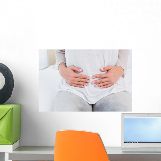 Mid section of woman with stomach pain Wall Decal