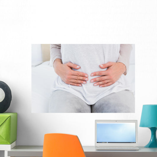 Mid section of woman with stomach pain Wall Decal