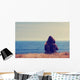 Girl sitting on a meadow with a beautiful sea/ocean view. Wall Decal