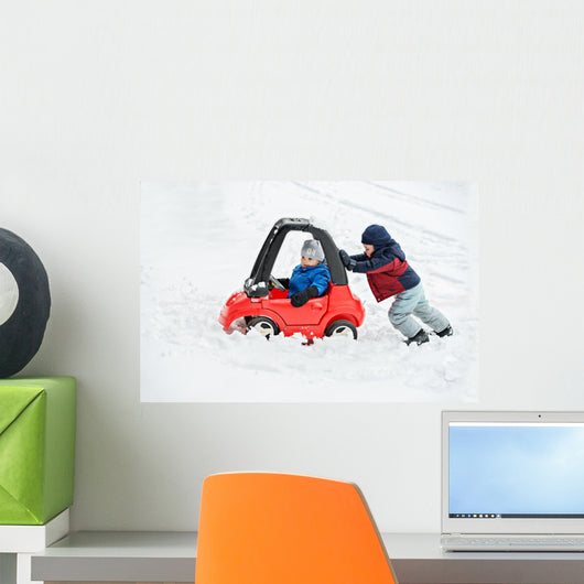 Young Boy Gives a Push to his Brother's Car Stuck in the Snow Wall Decal