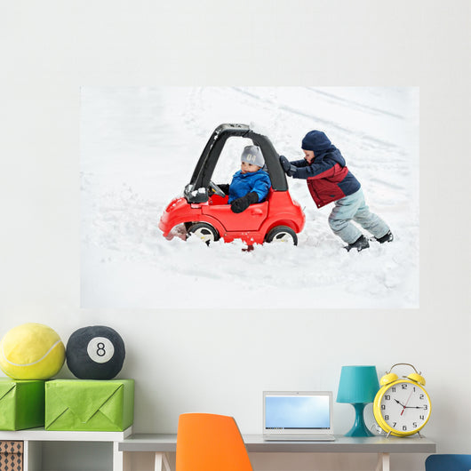 Young Boy Gives a Push to his Brother's Car Stuck in the Snow Wall Decal