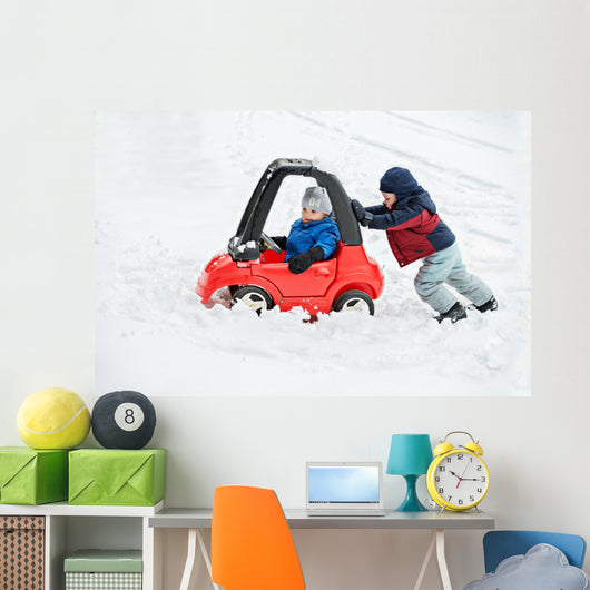 Young Boy Gives a Push to his Brother's Car Stuck in the Snow Wall Decal