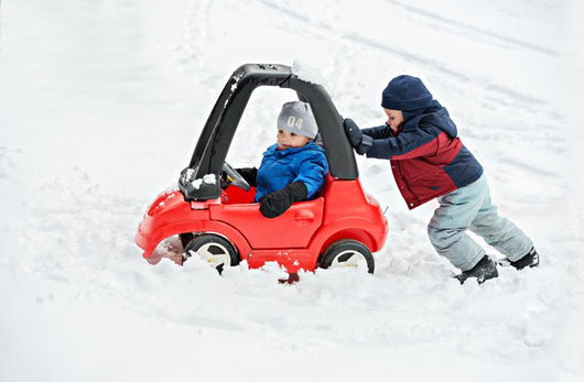Young Boy Gives a Push to his Brother's Car Stuck in the Snow Wall Decal