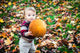 Wide Eyed Toddler Outside Holding a Big Pumpkin Wall Decal