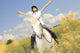 A white horse on yellow flower field with a rider. Wall Decal