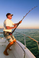 Angler fisherman fighting big fish on the ocean from the boat Wall Decal