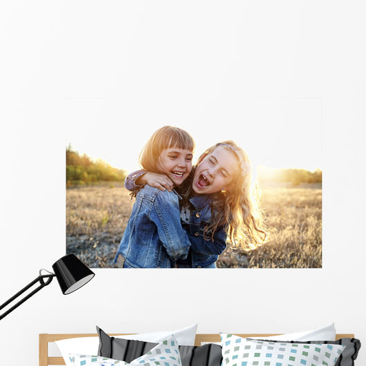 Two young girls have fun outside Wall Decal
