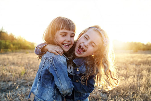 Two young girls have fun outside Wall Decal