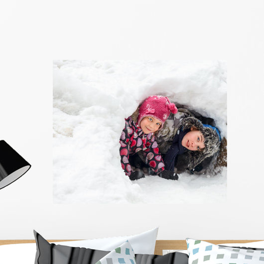 Children playing in a snow cave Wall Decal