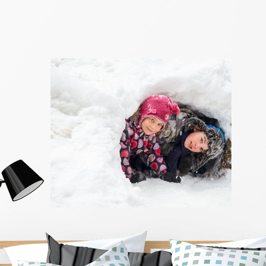Children playing in a snow cave Wall Decal
