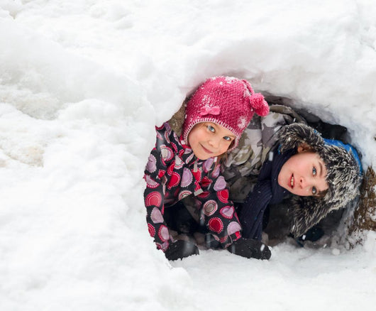 Children playing in a snow cave Wall Decal