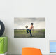 Boy playing football in the countryside Wall Decal