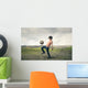 Boy playing football in the countryside Wall Decal