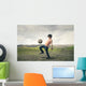 Boy playing football in the countryside Wall Decal