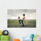 Boy playing football in the countryside Wall Decal