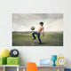 Boy playing football in the countryside Wall Decal