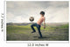 Boy playing football in the countryside Wall Decal