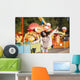 Amusement park rides. A young woman is happy and jumps. Wall Mural