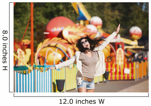 Amusement park rides. A young woman is happy and jumps. Wall Mural