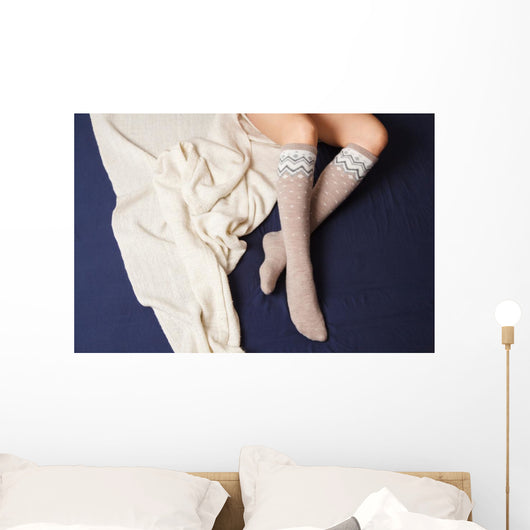 Female legs in warm woolen socks Wall Mural