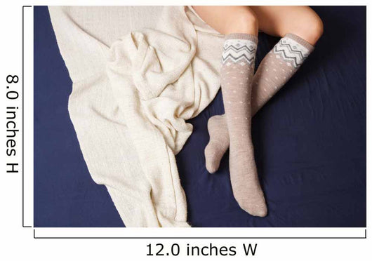 Female legs in warm woolen socks Wall Mural