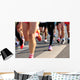 marathon runner legs running on city street Wall Mural