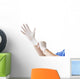 Doctor putting on sterile gloves Wall Decal