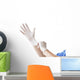 Doctor putting on sterile gloves Wall Decal