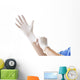 Doctor putting on sterile gloves Wall Decal