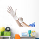Doctor putting on sterile gloves Wall Decal