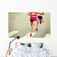 marathon runner legs running on city street Wall Mural