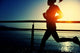 Young Fitness Woman Running On Sunrise Seaside Boardwalk Wall Decal