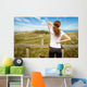 Athletic woman touching neck and back muscles by injury Wall Mural