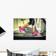 Fitness girl running on treadmill. With muscular legs in gym. Wall Mural