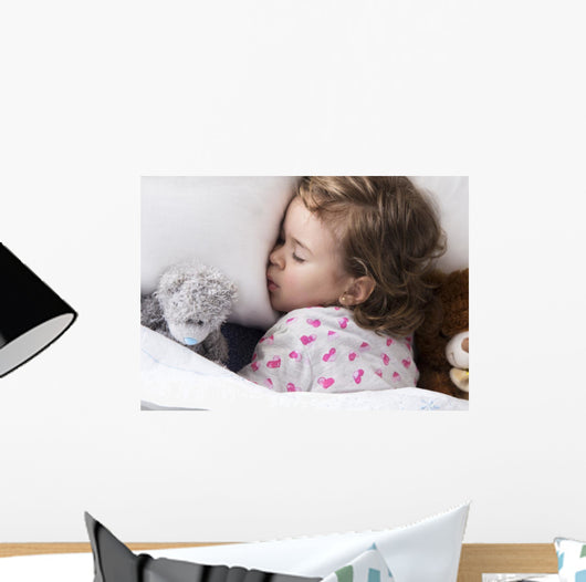 Sleeping child with toys Wall Mural