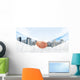 Hansshake of two businessmen on a city background Wall Mural