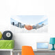 Hansshake of two businessmen on a city background Wall Mural