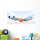 Hansshake of two businessmen on a city background Wall Mural