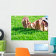 Family relaxing on the grass Wall Mural