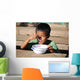 Child eating Wall Mural