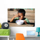 Child eating Wall Mural
