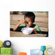 Child eating Wall Mural