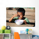 Child eating Wall Mural