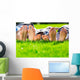 Family relaxing on the grass Wall Mural